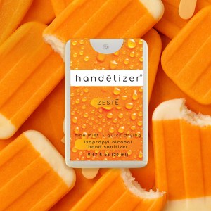 Front facing view of the Zestē hand sanitizer spray with orange cream popsicles in the background